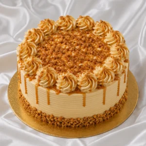 Butterscotch cake with creamy caramel
frosting, golden drizzle and crunchy praline pieces on a gold cake board