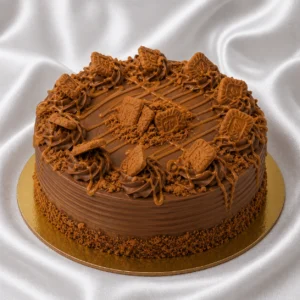 Chocolate Biscoff cake with cookie
  crumbs, biscuit pieces and caramelized drizzle