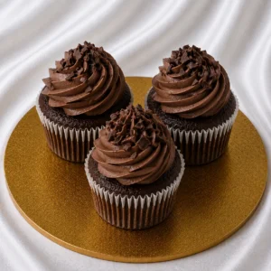 Set of chocolate cupcakes with smooth
chocolate frosting and chocolate shavings on a bakery surface
