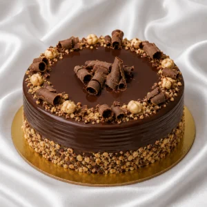 Chocolate hazelnut cake with glossy
  ganache, roasted hazelnuts and chocolate curls