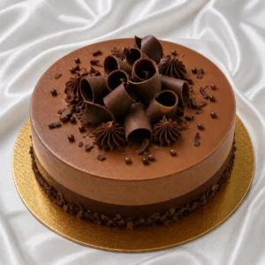 Elegant chocolate mousse cake with glossy
  mousse topping and delicate chocolate curls