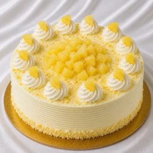 Pineapple cake with light whipped cream
  frosting and juicy pineapple pieces