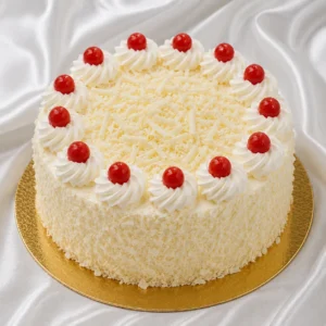 White Forest cake with white chocolate
and whipped cream frosting, chocolate shavings and cream decoration